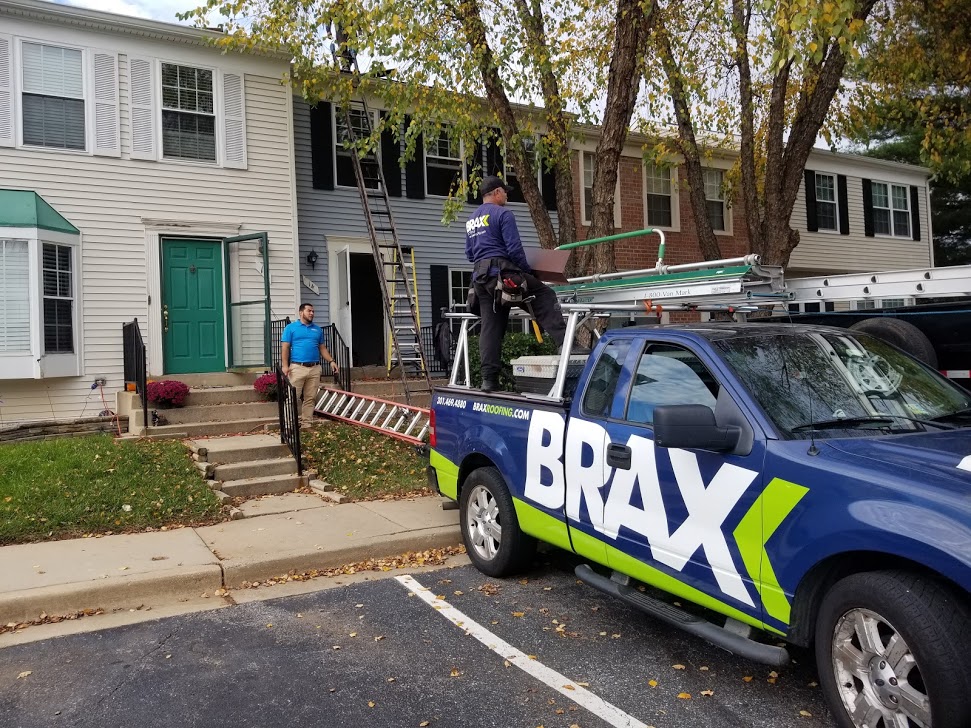 Brax roofing truck parked outside of townhomes