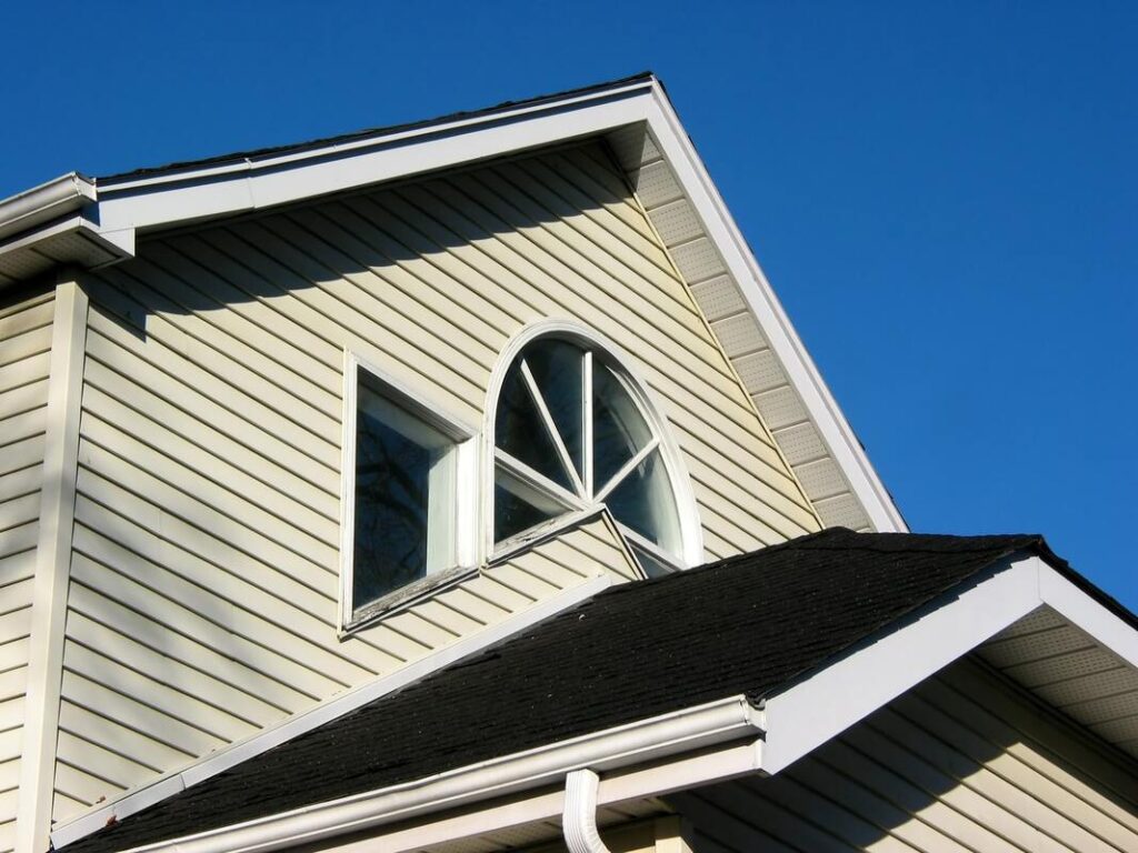 Beige vinyl siding on a two-story home